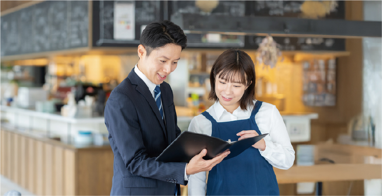 飲食店内で男性と女性が話し合いをしている写真